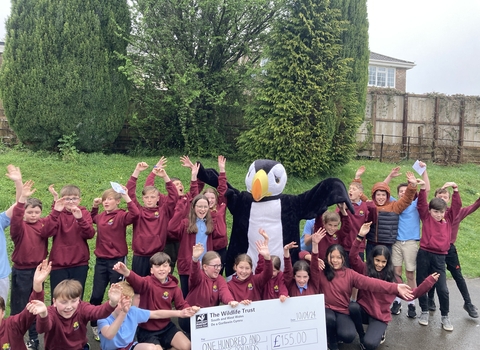 A group of a school children with our puffin mascot. 