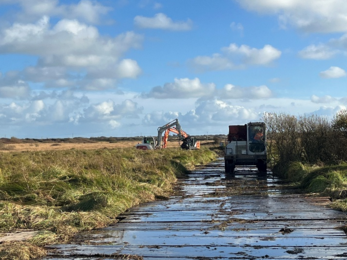 Van and digger on board walk at Dowrog Common