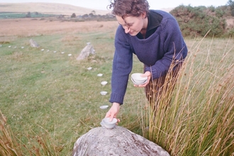 Linda Unsworth laying down a wild clay bowl