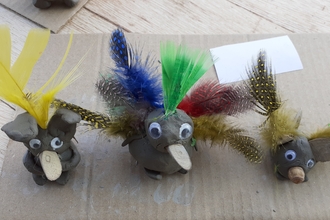 Birds made from clay and colourful feathers
