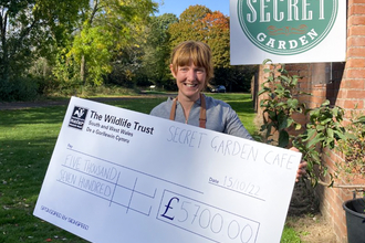 Mel from Secret Garden Cafe with fundraising cheque