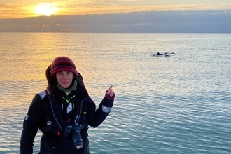 Dr Sarah Perry, surveying dolphins