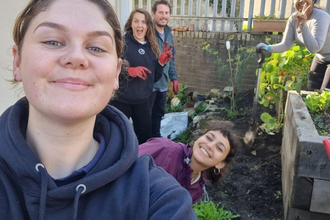 A group of people in a garden. 