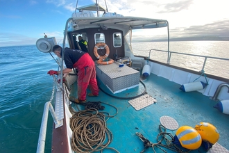 CBMWC Nature Networks Acoustic Researcher on boat in Cardigan Bay