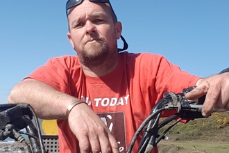 Paul on a quad bike on a sunny day.