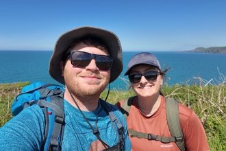 Fundraisers Joe and Maddy wearing sunglasses on their walk