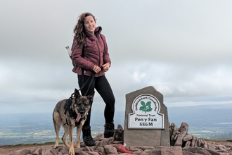 Sarah with her dog on top of Pen y Fan. 