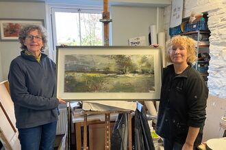 Artist Maggie Brown with landscape painting 
