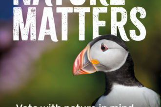 Poster with a large photo of a puffin. The title says 'Nature Matters'. Text says 'Vote with nature in mind this Senedd Election'.