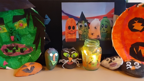 Pebbles and plates decorated for Halloween