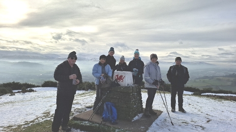 Brecon Local Group members by a trig point in snow