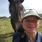 A woman talking a selfie with horse. 