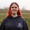 Marianne stood in a field with a WTSWW hoody on. 