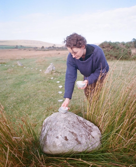 Linda Unsworth laying down a wild clay bowl