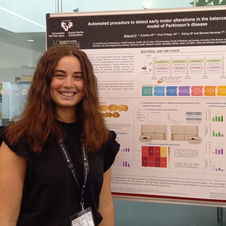 Raphaëlle standing in front of an academic poster. 