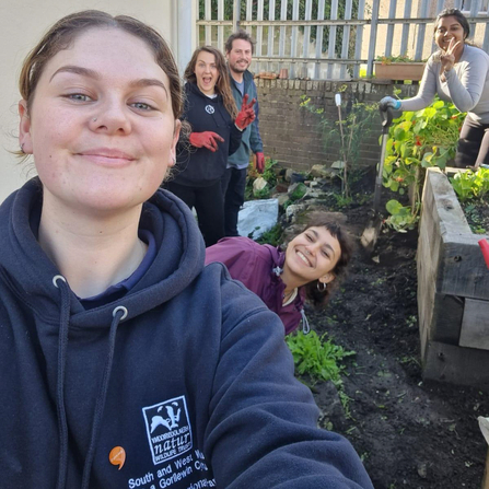 Marianne with a group of people in a garden. 