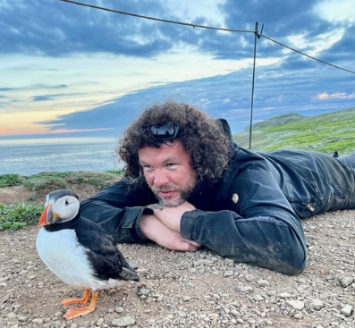 Kevin Morgans looks at a Puffin on the Wick.