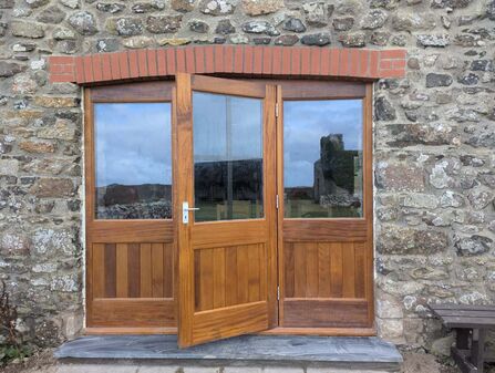 Wooden hostel doors on Skomer at the farm