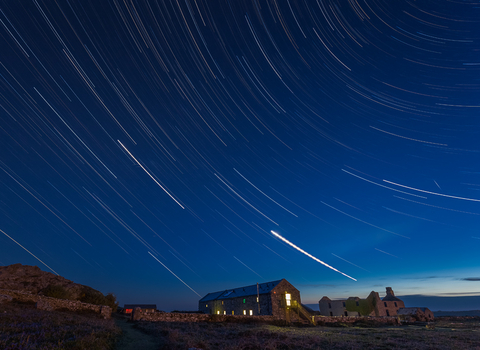 The Skomer hostel at night with the stars above.