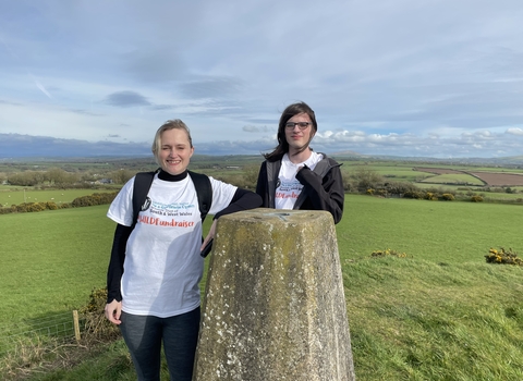 Donna and family at a trig point. 