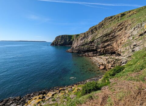 South Stream bay stretches around the right-hand side with a bright sky behind.